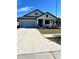 Single-story home with light blue exterior, landscaping, and a two-car garage at 12119 Creek Preserve Dr, Riverview, FL 33579