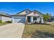 Newly built home with light blue exterior, landscaping, and a two-car garage at 12119 Creek Preserve Dr, Riverview, FL 33579