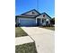 Front view of a single-story house with light blue siding and a two-car garage at 12119 Creek Preserve Dr, Riverview, FL 33579