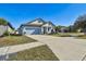 Newly built home with light blue exterior, landscaping, and a two-car garage at 12119 Creek Preserve Dr, Riverview, FL 33579