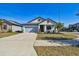 Newly built home with light blue exterior, landscaping, and a two-car garage at 12119 Creek Preserve Dr, Riverview, FL 33579