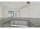 Modern kitchen sink with stainless steel basin and granite countertop at 12119 Creek Preserve Dr, Riverview, FL 33579