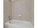 Clean shower/tub with beige tile surround at 12119 Creek Preserve Dr, Riverview, FL 33579