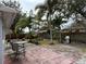 Relaxing backyard with patio, grill, and tropical landscaping at 12264 103Rd St, Largo, FL 33773