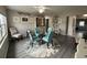 Dining room with glass table, four teal chairs, and area rug at 12264 103Rd St, Largo, FL 33773