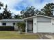 House exterior with gray roof, white brick, and lawn at 12264 103Rd St, Largo, FL 33773