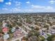 Aerial view of a single Gathering home with a large backyard, located in a residential neighborhood near the water at 13472 Bellewood Ave, Seminole, FL 33776