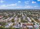 Aerial view of a single Gathering home with a large backyard, located in a residential neighborhood near the water at 13472 Bellewood Ave, Seminole, FL 33776