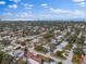 Aerial view showcasing the home's neighborhood and proximity to the water at 13472 Bellewood Ave, Seminole, FL 33776