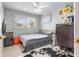 Well-lit bedroom with a full-size bed and workspace at 13472 Bellewood Ave, Seminole, FL 33776