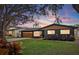 Charming mid-century modern home with a landscaped yard at 13472 Bellewood Ave, Seminole, FL 33776