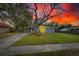 Charming ranch home at sunset, featuring a large tree at 1434 Longwood Loop, Tampa, FL 33619