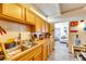 Bright kitchen features ample wood cabinets and a double sink at 1434 Longwood Loop, Tampa, FL 33619