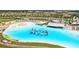 Lagoon pool with inflatable water park and beach area at 16961 Oval Rum Dr, Wimauma, FL 33598