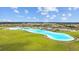 Expansive lagoon pool with surrounding community at 16961 Oval Rum Dr, Wimauma, FL 33598