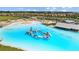 Aerial view of lagoon pool with floating obstacle course at 16961 Oval Rum Dr, Wimauma, FL 33598