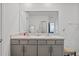 Double vanity bathroom with a large mirror at 16961 Oval Rum Dr, Wimauma, FL 33598