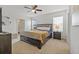 Bright bedroom with a king-size bed and ensuite bathroom at 16961 Oval Rum Dr, Wimauma, FL 33598