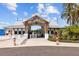 Inviting community entrance with white building and landscaping at 16961 Oval Rum Dr, Wimauma, FL 33598