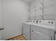 Laundry room with washer, dryer, and shelving at 16961 Oval Rum Dr, Wimauma, FL 33598