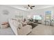 Bright living room with comfortable seating and large windows at 16961 Oval Rum Dr, Wimauma, FL 33598