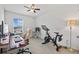 Home office with a desk, chair, and Peloton bike at 16961 Oval Rum Dr, Wimauma, FL 33598