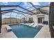 Modern, covered pool and patio area with lounge chairs and seating at 16961 Oval Rum Dr, Wimauma, FL 33598