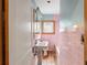 Pink tiled bathroom with pedestal sink and bathtub at 17 Venetian Ct, Tarpon Springs, FL 34689