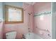 Pink tiled bathroom with shower and grab bars at 17 Venetian Ct, Tarpon Springs, FL 34689