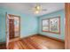 Light blue bedroom with wood floors and built-in closet at 17 Venetian Ct, Tarpon Springs, FL 34689