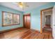 Light blue bedroom with wood floors and two windows at 17 Venetian Ct, Tarpon Springs, FL 34689