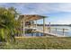 Covered boat lift with a spacious dock overlooking the water at 17 Venetian Ct, Tarpon Springs, FL 34689