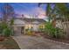 House exterior at dusk, showcasing landscaping and driveway at 17 Venetian Ct, Tarpon Springs, FL 34689