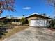 Ranch-style home with a driveway and an attached garage at 1700 Kay Dr, Largo, FL 33770