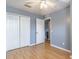 Light-filled bedroom with wood floors and double door closet at 17533 Stinchar Dr, Land O Lakes, FL 34638