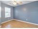 Light-filled bedroom with wood floors and ceiling fan at 17533 Stinchar Dr, Land O Lakes, FL 34638