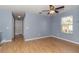 Bright bedroom with wood floors and access to hallway at 17533 Stinchar Dr, Land O Lakes, FL 34638