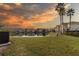 Residential community with lakefront view showcasing serene sunset colors at 17533 Stinchar Dr, Land O Lakes, FL 34638