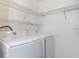 Laundry room with washer, dryer, and shelving at 17533 Stinchar Dr, Land O Lakes, FL 34638