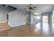 Spacious living room with hardwood floors and a view of the kitchen at 17533 Stinchar Dr, Land O Lakes, FL 34638