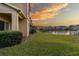 View of a lake with townhomes in the background and grassy areas at 17533 Stinchar Dr, Land O Lakes, FL 34638