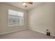 Well-lit bedroom with large window and carpet at 18420 Burrell Rd, Odessa, FL 33556