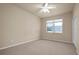 Spacious bedroom with ceiling fan and large window at 18420 Burrell Rd, Odessa, FL 33556