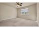 Large bedroom with window and ceiling fan at 18420 Burrell Rd, Odessa, FL 33556