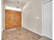 Entryway with double wooden doors and tile flooring at 18420 Burrell Rd, Odessa, FL 33556