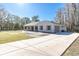 Exterior view of a single-story house with a large driveway at 18420 Burrell Rd, Odessa, FL 33556