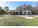 House exterior showcasing a front porch and landscaping at 18420 Burrell Rd, Odessa, FL 33556