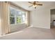 Bright living room with large windows and neutral carpeting at 18420 Burrell Rd, Odessa, FL 33556