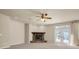 Living room with a stone fireplace and French doors leading outside at 18420 Burrell Rd, Odessa, FL 33556