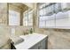 Bathroom with gray vanity, tile flooring, and a window for natural light at 216 21St Ne Ave, St Petersburg, FL 33704